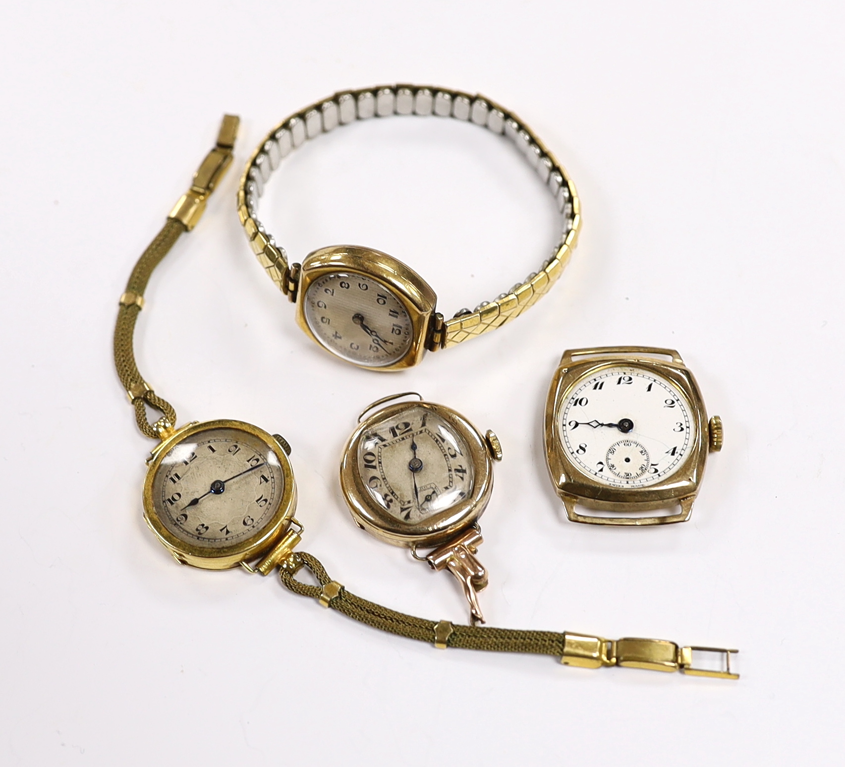 A lady's 18ct gold manual wind wrist watch on a twin fabric strap and three similar 9ct gold wrist watches.